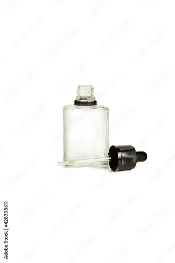 A bottle with a pipette, isolated on a white background. glass container for cosmetic skin care products. Aromatherapy, essence, or perfume is empty. a bottle of cosmetic dropper. A bottle with a pipette, isolated on a white background. glass container for cosmetic skin care products. Aromatherapy, essence, or perfume is empty. a bottle of cosmetic dropper.