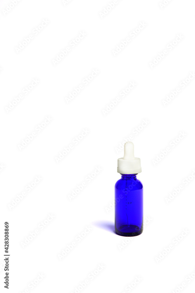 blue glass bottles.A bottle with a pipette, isolated on a white background. glass container for cosmetic skin care products. Aromatherapy, essence, or perfume is empty. a bottle of cosmetic dropper. blue glass bottles.A bottle with a pipette, isolated on a white background. glass container for cosmetic skin care products. Aromatherapy, essence, or perfume is empty. a bottle of cosmetic dropper.