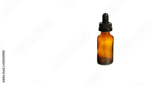 Brown glass bottles.A bottle with a pipette, isolated on a white background. glass container for cosmetic skin care products. Aromatherapy, essence, or perfume is empty. a bottle of cosmetic dropper. 