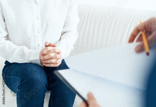 cropped view of man with folder of documents and women putting on indoors © SHOTPRIME STUDIO