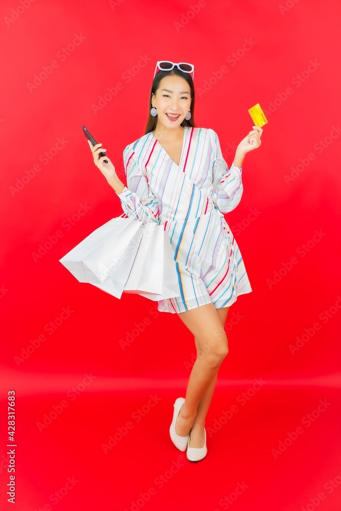 Portrait beautiful young asian woman with credit card and shopping bag Portrait beautiful young asian woman with credit card and shopping bag