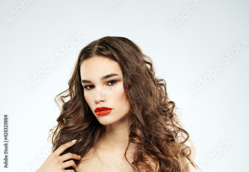 Woman portrait bright makeup curly hair nude shoulders model