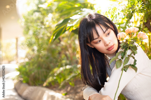 youbg Asian woman holding a flower photo