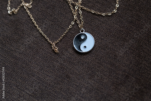 Yin Yang pendant necklace handmade black and white closeup. Selective Focus. High quality photo