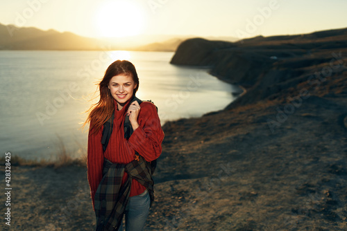 woman hiker with backpack outdoors landscape rocky mountains