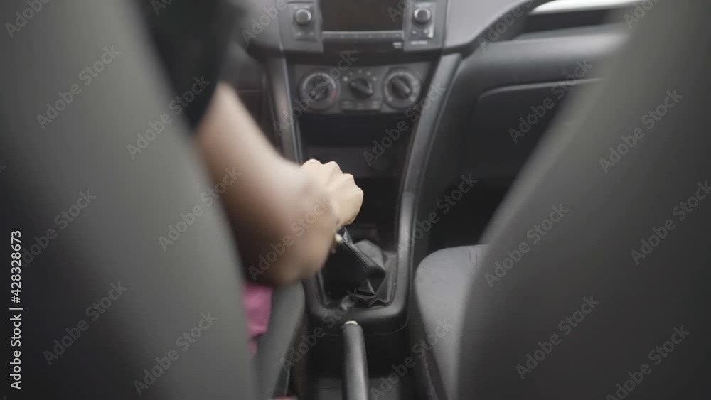 hand of an unrecognizable young man changing speed in his car hand of an unrecognizable young man changing speed in his car