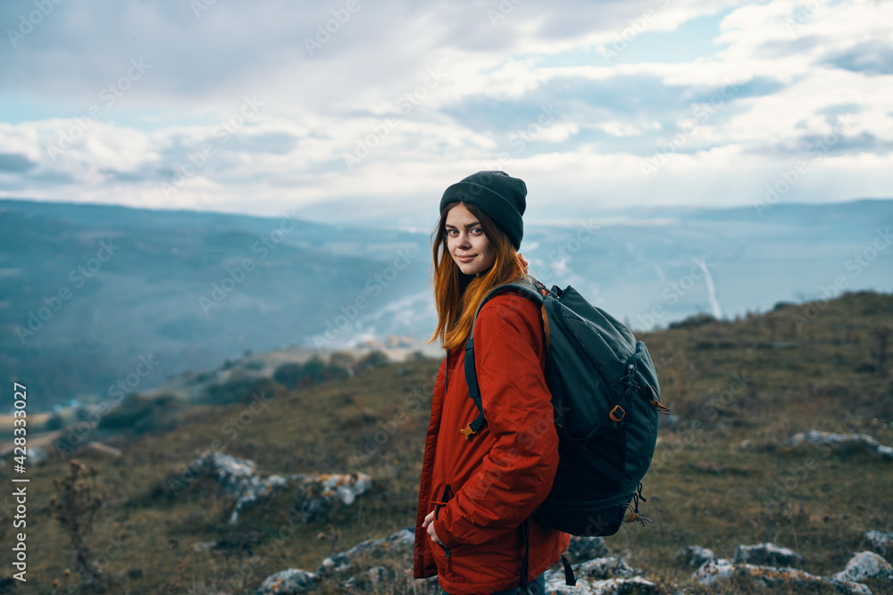 Obraz premium portrait of a traveler in the mountains in nature rock landscape clouds sky model