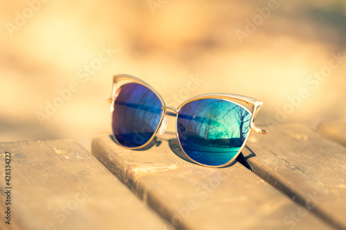 Wallpaper Mural Fashion cat eye sunglasses model for ladies with black lenses and golden frame shoot outside in a sunny day closeup. Selective focus . High quality photo Torontodigital.ca