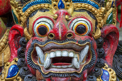 Traditional Balinese demon statue in the street temple. Island Bali, Indonesia © OlegD