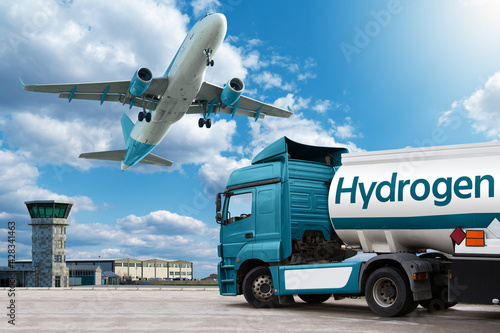 Airplane and truck with hydrogen tank trailer on the background of airport. Clean mobility concept 