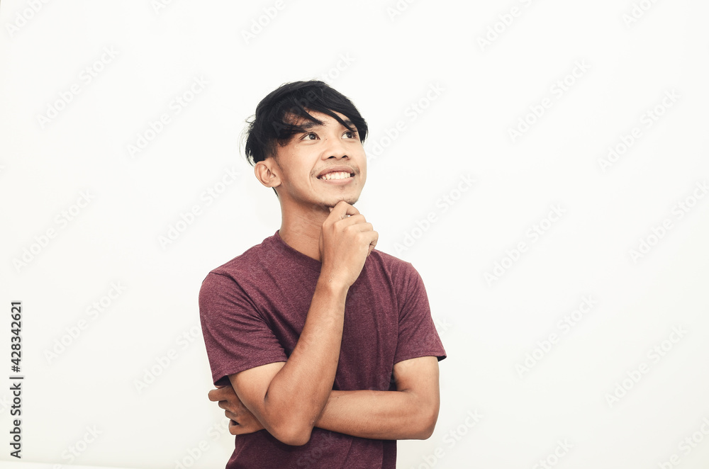 The Asian man smiled in a casual shirt with a thoughtful expression The Asian man smiled in a casual shirt with a thoughtful expression