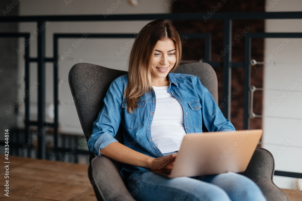 Fototapeta premium Progressive young woman working remotely from home