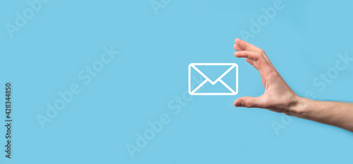Male hand holding letter icon,email icons .Contact us by newsletter email and protect your personal information from spam mail. Customer service call center contact us.Email marketing and newsletter