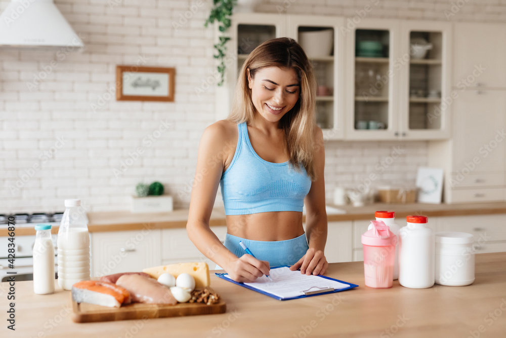 Positive woman taking notes about her nutrition habits