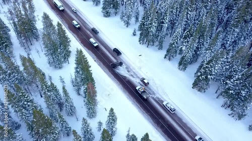 Pickup truck vehicle got into an accident and overturned in the middle of icy road up in the mountains during winter season.