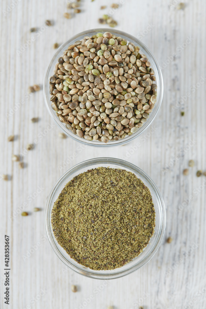 hemp powder in a bowl on white wooden surface hemp powder in a bowl on white wooden surface