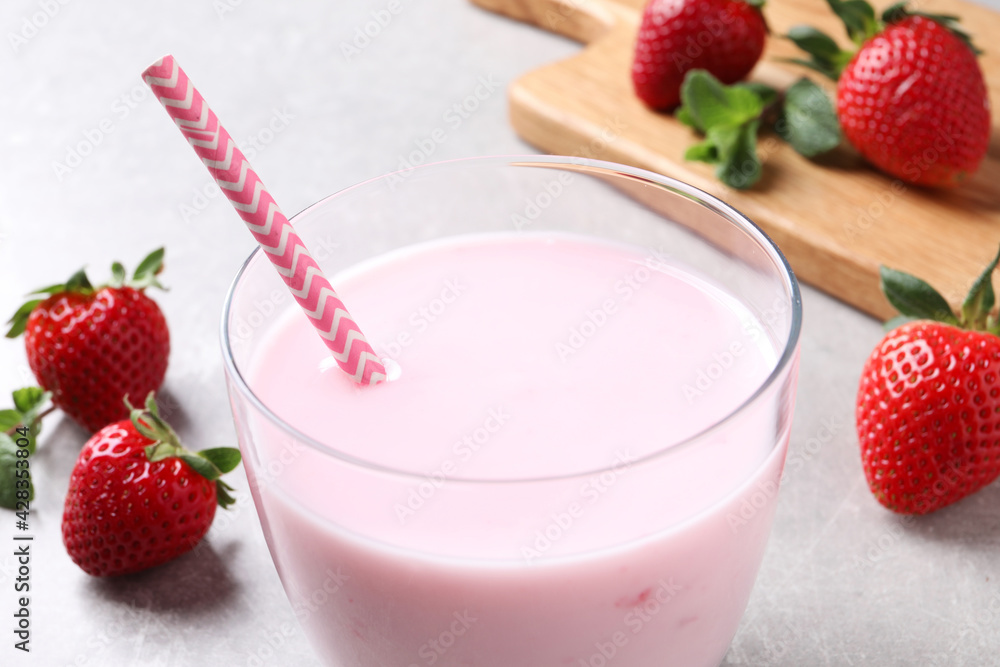 Delicious strawberry drink on light grey table, closeup Delicious strawberry drink on light grey table, closeup