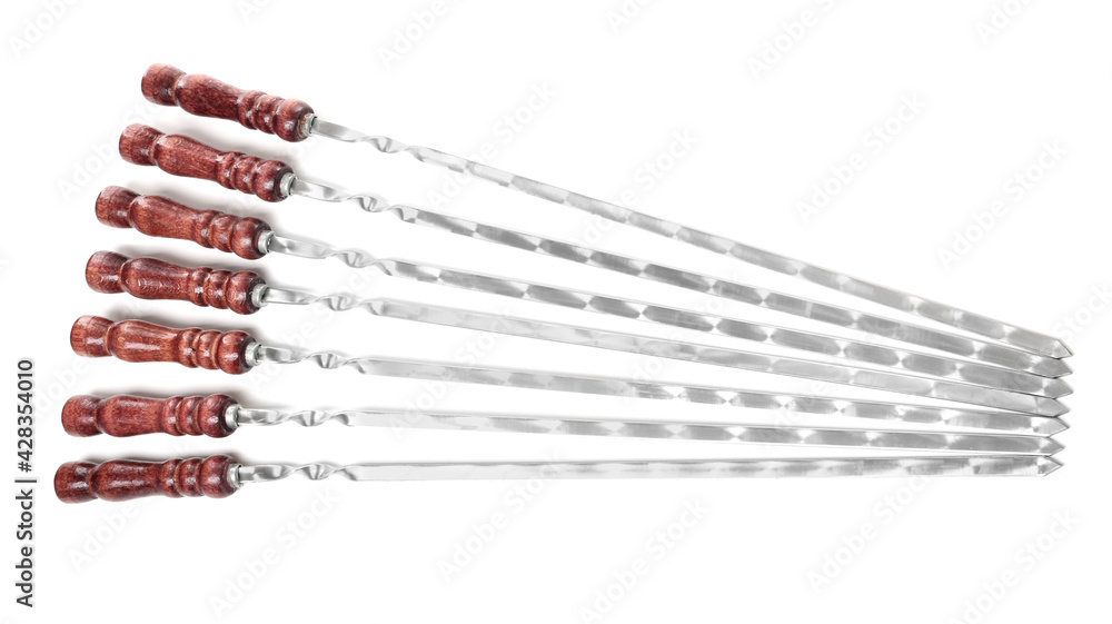 Metal skewers with wooden handle on white background, top view Metal skewers with wooden handle on white background, top view