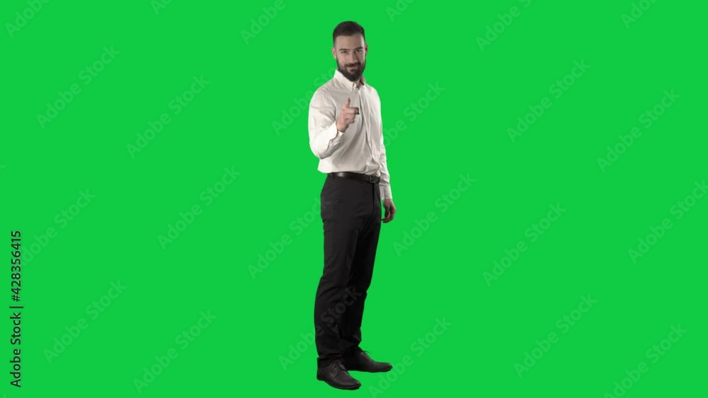Side view of business man turning at camera pointing finger choosing you. Full length on green screen chroma key background. Side view of business man turning at camera pointing finger choosing you. Full length on green screen chroma key background.