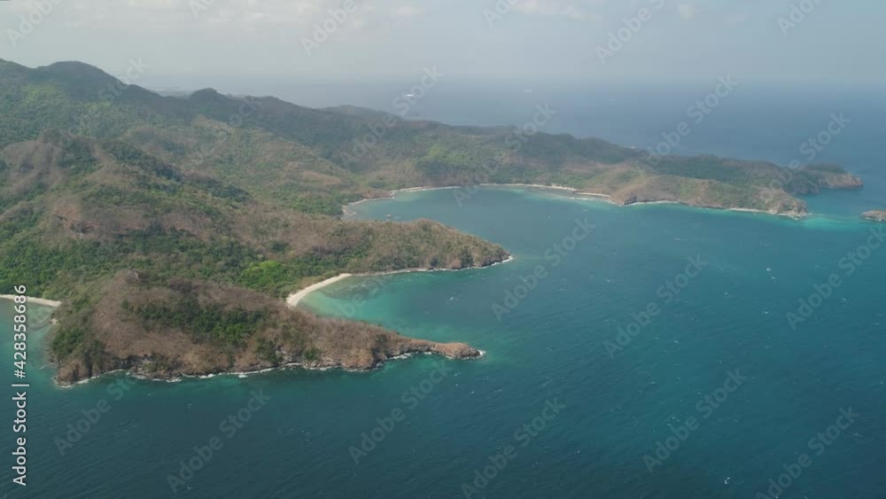Aerial view coastline with tropical beach, island Limbones, lagoons and coral reefs. Neela cove, Philippines, Luzon. Coast ocean with turquoise water. Tropical landscape in Asia. Aerial view coastline with tropical beach, island Limbones, lagoons and coral reefs. Neela cove, Philippines, Luzon. Coast ocean with turquoise water. Tropical landscape in Asia.