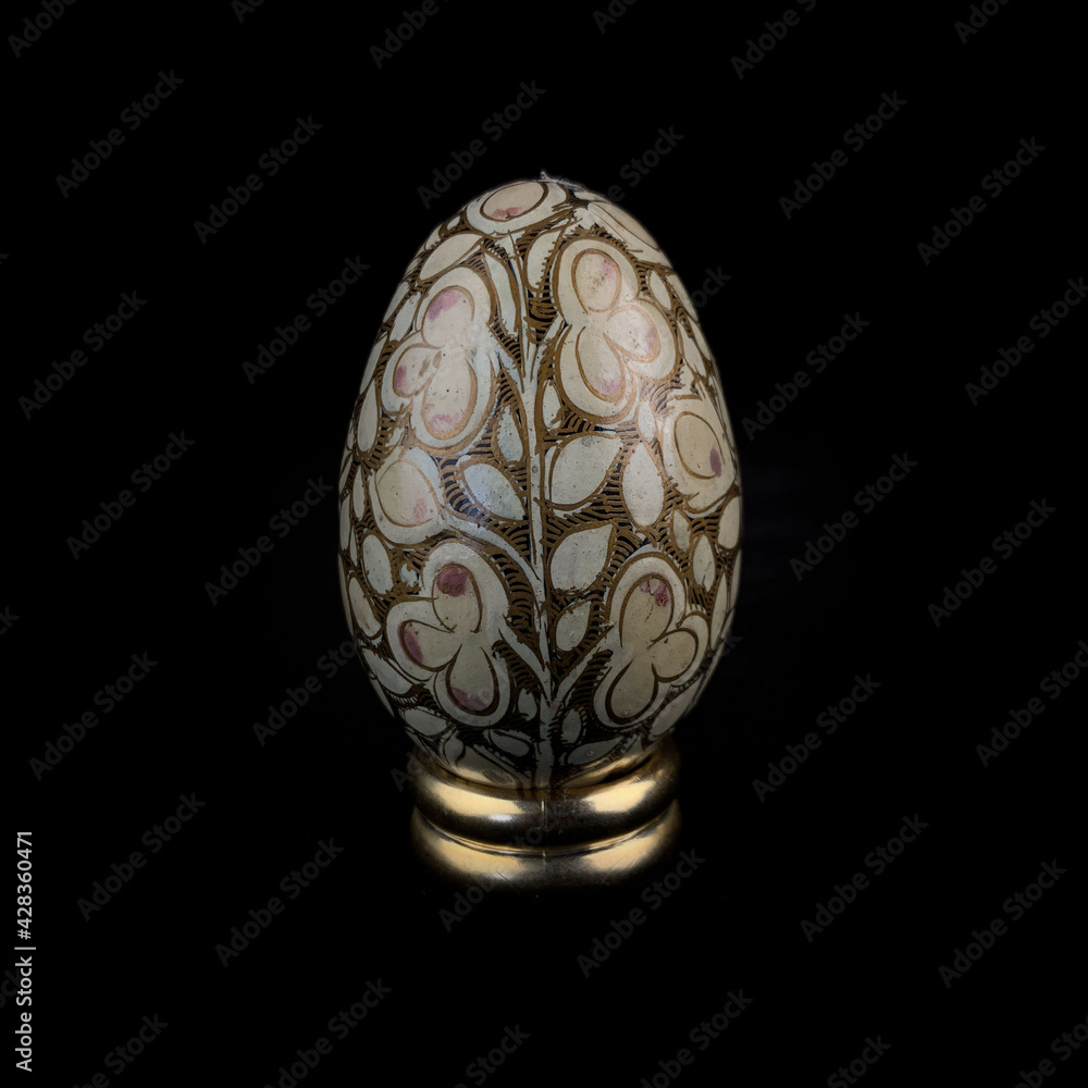 wooden Easter egg with floral patterns on isolated black background wooden Easter egg with floral patterns on isolated black background