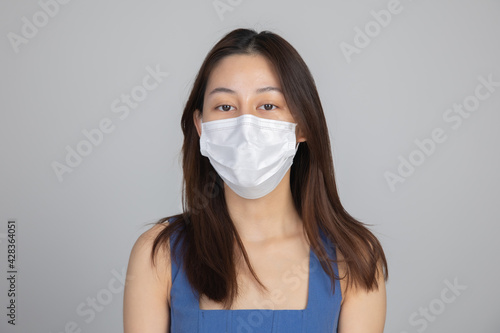 Young happy Asian woman wearing hygienic mask to prevent infection corona virus Air pollution pm2.5 .Health care and coronavirus concept.