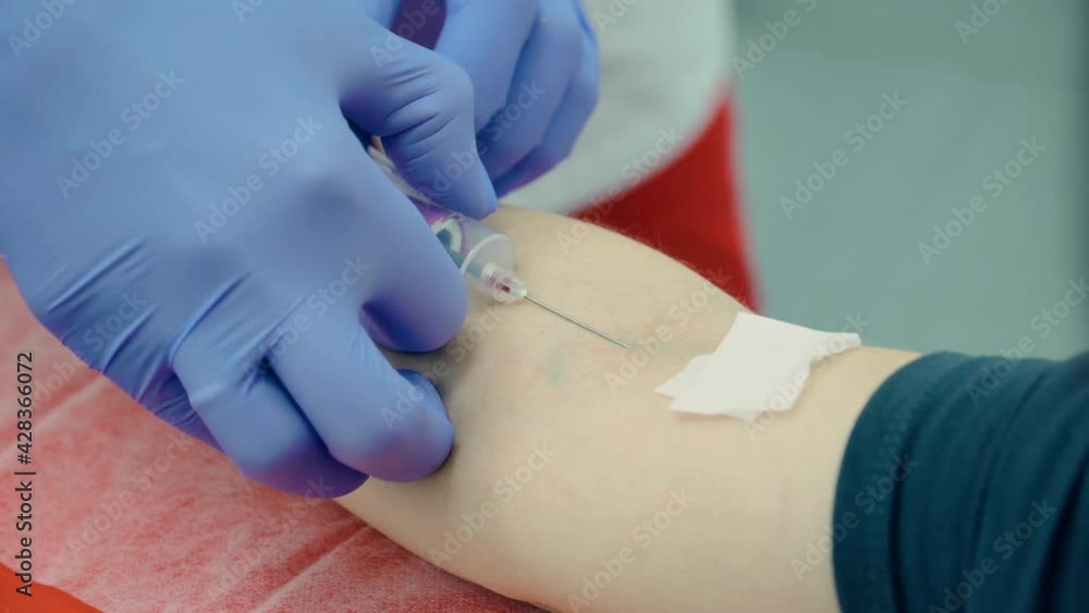Close up of process of drawing venous blood into test tube from patient hand using medical device syringe with needle in laboratory of hospital or health care center. Medicines research concept and Close up of process of drawing venous blood into test tube from patient hand using medical device syringe with needle in laboratory of hospital or health care center. Medicines research concept and