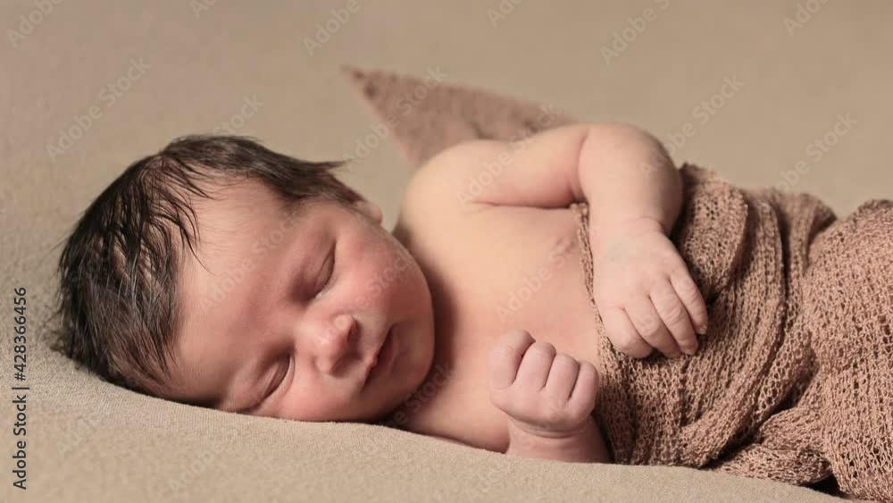 Cute infant girl lying in bed wake up close up. Looking at camera. Childhood. First days of new life. Cute infant girl lying in bed wake up close up. Looking at camera. Childhood. First days of new life.