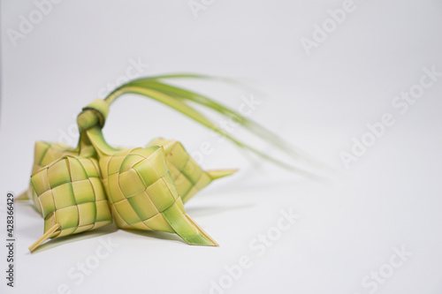 Ketupat is a traditional Indonesian food  usually eaten during Eid al-Fitr  with white background
