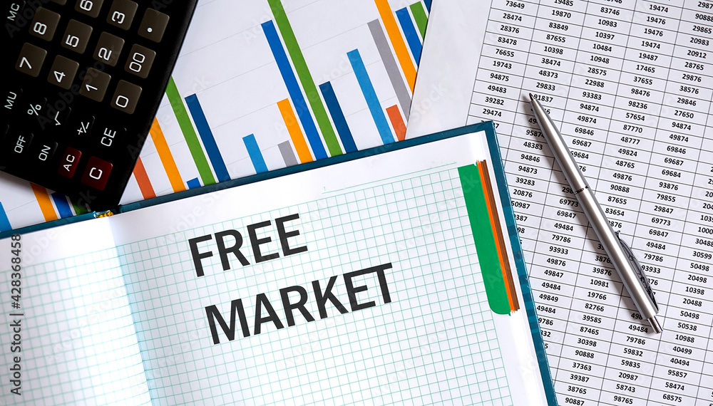 FREE MARKET memo written on a notebook with pen and chart FREE MARKET memo written on a notebook with pen and chart