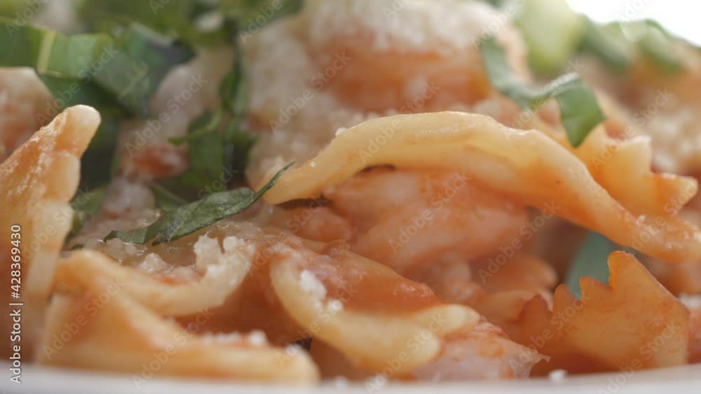 A close up view of pasta with shrimp and parmesan cheese. A close up view of pasta with shrimp and parmesan cheese.