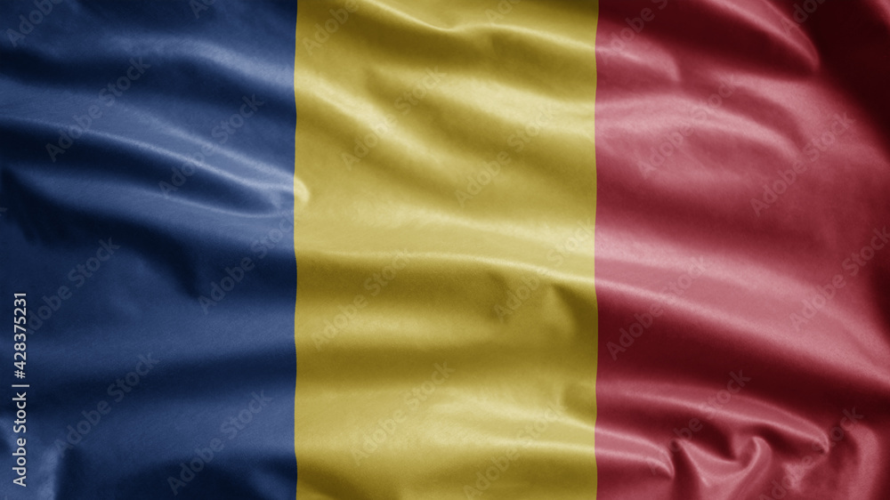 Romanian flag waving in the wind. Close up of Romania banner blowing soft silk.