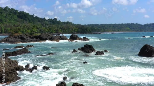 Drone flies over the stony coast with sea, waves and clouds in Corkovado National Park on Osa Peninsula, Costa Rica photo