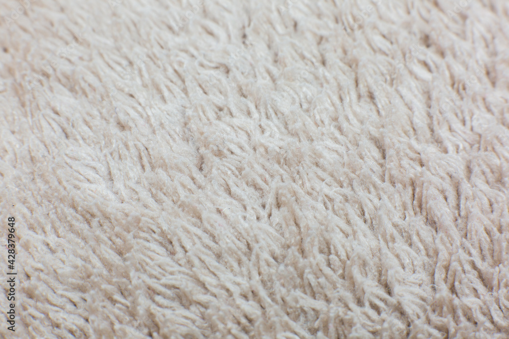 Beige cotton towel or carpet.fluffy texture background. Close up, macro photo. Soft focus image. Beige cotton towel or carpet.fluffy texture background. Close up, macro photo. Soft focus image.
