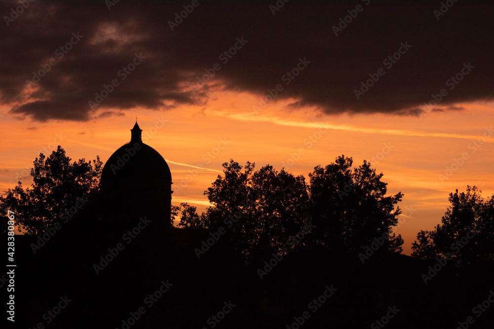 Sunset dome between clouds in a village in the Padana plain, Italy