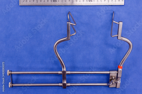 Tablou pe pânză Gosset abdominal retractor on a blue background