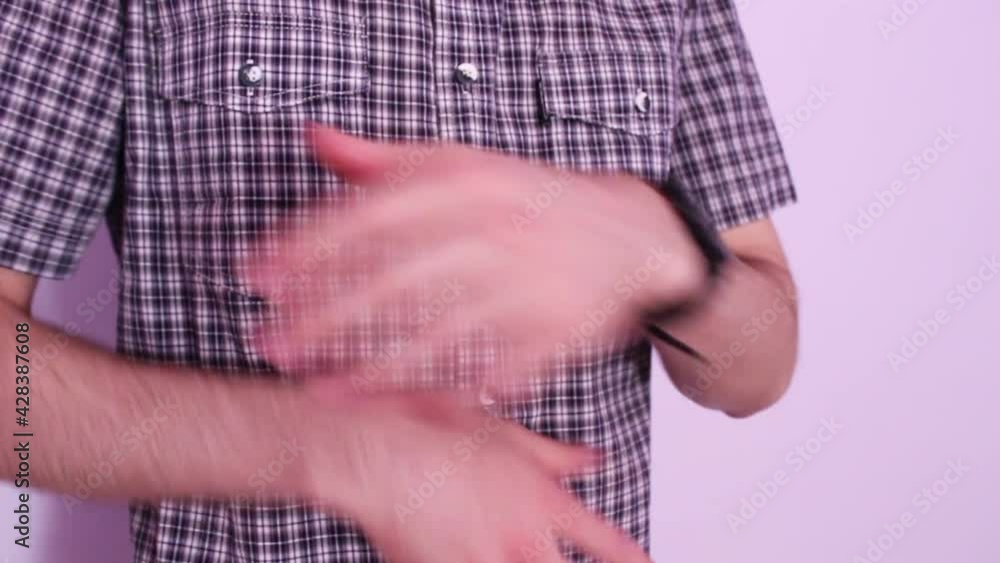 Young man in a plaid shirt. The guy is gesticulating with his hands Young man in a plaid shirt. The guy is gesticulating with his hands