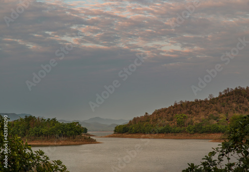 View of lake shore with mountains range in background. Selective focus.