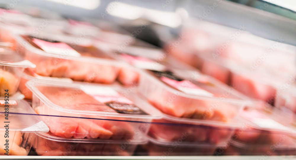 Meat products put up for sale in a supermarket commercial fridge