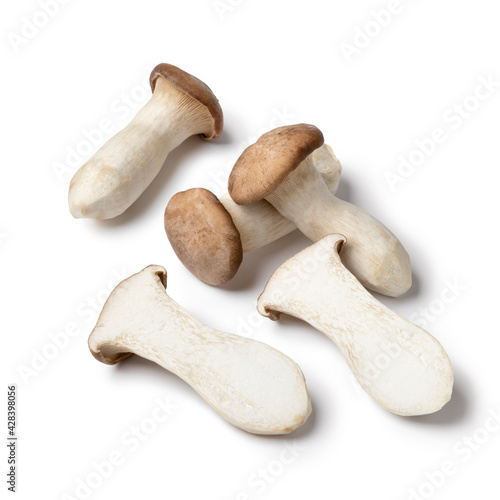 Whole and halved fresh raw king oyster mushrooms isolated on white background 