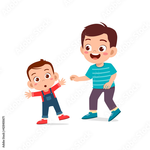 cute little boy play with baby sibling together and learn to walk