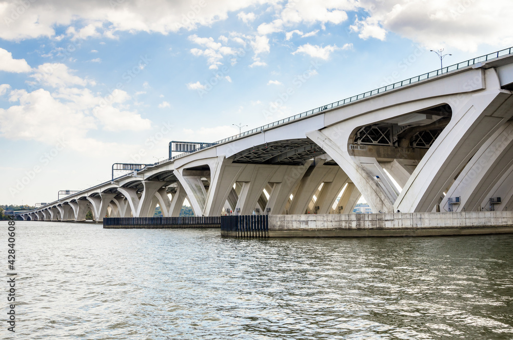 Modern highway bridge spanning a mighty river on a clear autumn morning Modern highway bridge spanning a mighty river on a clear autumn morning