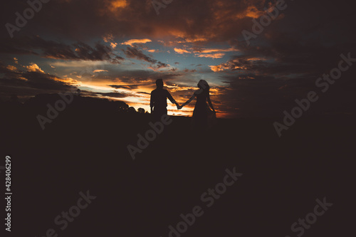 romantic couple walking at sunset