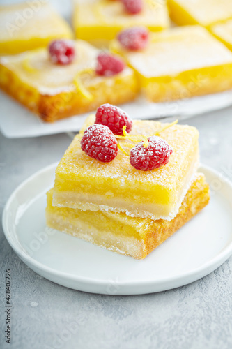 Lemon pie squares topped with rasperries, homemade dessert photo