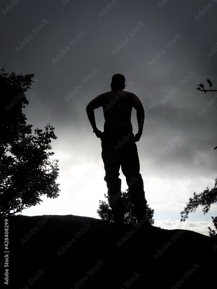 boy back light shot in deep green forests feeling the true nature