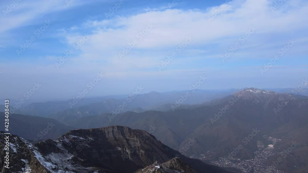Magnifficent view from drone on white snowy peaks on foggy bright day. Aerial shot of mountain range covered in snow from up high. Concept of travel, inspiring, nature, winter. Magnifficent view from drone on white snowy peaks on foggy bright day. Aerial shot of mountain range covered in snow from up high. Concept of travel, inspiring, nature, winter.
