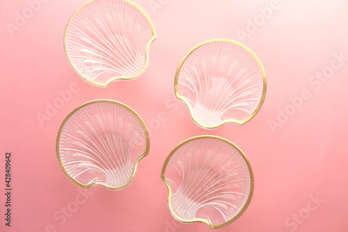 top view of many empty bowl on pink background 