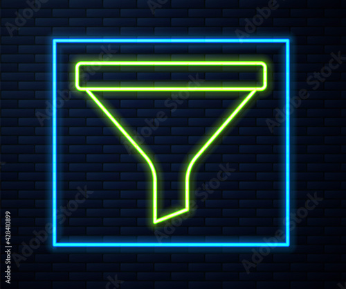 Glowing neon line Funnel or filter icon isolated on brick wall background. Vector