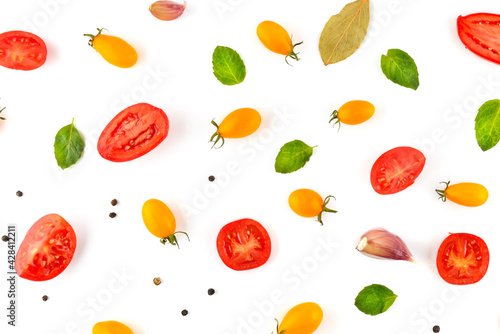 Fototapeta Naklejka Na Ścianę i Meble -  Beautiful background of yellow and red tomatoes, spices and green leaves.