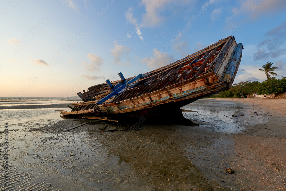 A shipwreck on the beach during low tide